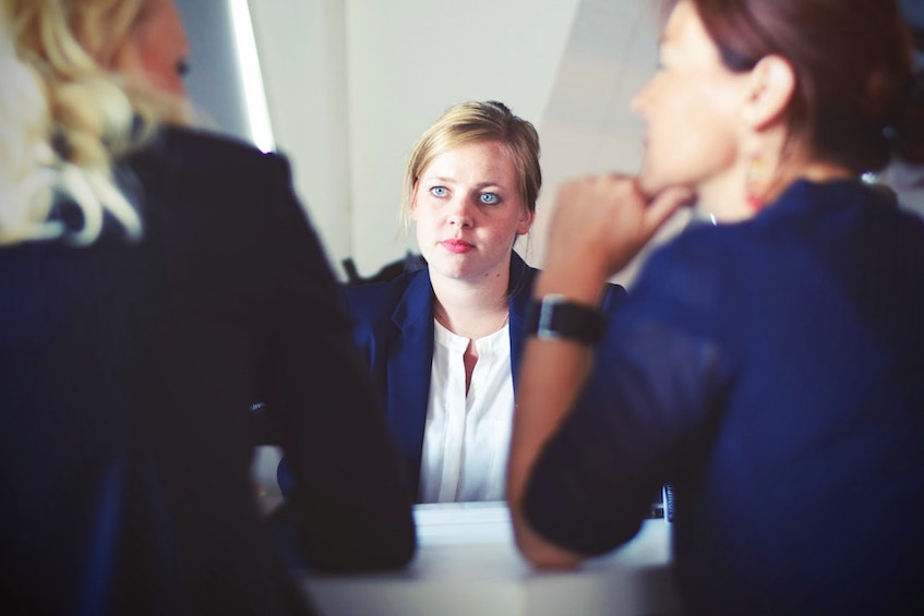Woman looking anxious in meeting